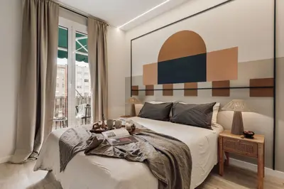 a balcony with two chairs and a table with food on it at Davut - 3 bedrooms and office in Eixample Esquerra in Barcelona