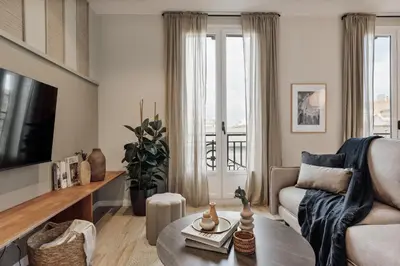 a living room with a couch and a table at Davut - 3 bedrooms and office in Eixample Esquerra in Barcelona
