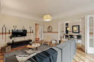 a living room with a couch and a tv at Sark - 3 bedrooms and balcony in Sant Gervasi in Barcelona