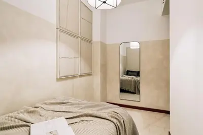 a living room with a couch and a plant at Tramonto - 3 bedrooms and balcony in Sant Antoni in Barcelona