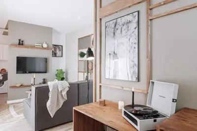 a living room with a gray couch and christmas decorations at Nerja - 1 bedroom and terrace in Sant Gervasi in Barcelona
