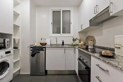 a living room with a couch and a table at Yesil - 2 bedrooms and office in Sant Antoni in Barcelona