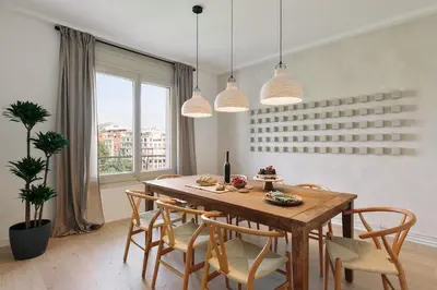 a dining room with a wooden table and chairs at Rama - 3 bedrooms and terrace in Sant Gervasi in Barcelona