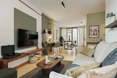 a living room with a couch and a tv at Mercan - 2 bedrooms in Sant Pere in Barcelona