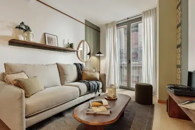 a living room with a couch and a table at Mercan - 2 bedrooms in Sant Pere in Barcelona
