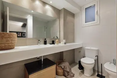 a bedroom with a large bed and a mirror at Caliph - 2 bedrooms and office in El Putxet i el Farró in Barcelona