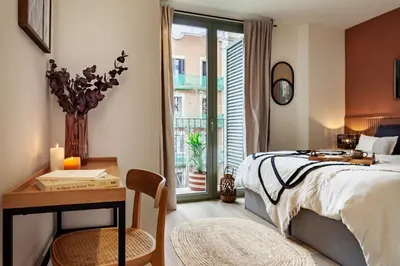 a kitchen with white cabinets and a tile wall at Kufra - 3 bedrooms in Eixample Esquerra in Barcelona