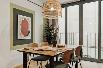 a kitchen with a table with chairs and a dining room at Peri - 2 bedrooms in Sant Pere in Barcelona