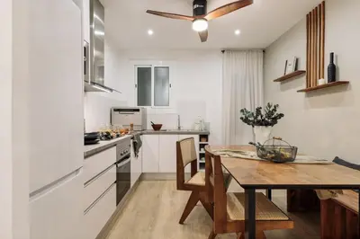a kitchen with a table and a ceiling fan at Holzer - 2 bedrooms in Sant Antoni in Barcelona