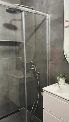 a shower with a glass door in a bathroom at Miro Park céntrico 5pax in Barcelona