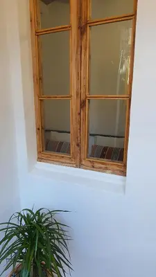 a wooden window with a potted plant in front of it at Miro Park céntrico 5pax in Barcelona
