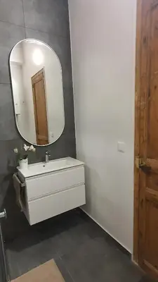a bathroom with a white sink and a mirror at Miro Park céntrico 5pax in Barcelona