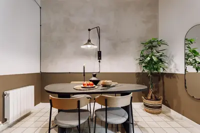 a living room with a brick wall with a tv at Sabre - 2 bedrooms and office in Gràcia in Barcelona