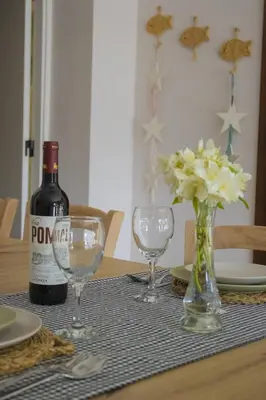 a bottle of wine and two glasses on a table at LAMAGADA - Casa en Montseny con Piscina Salada in Seva