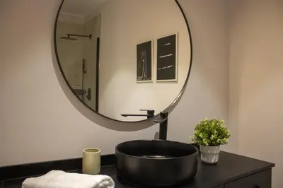a bathroom with a black sink and a mirror at LAMAGADA - Casa en Montseny con Piscina Salada in Seva