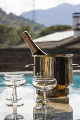 a metal pot and two glasses on a table at LAMAGADA - Casa en Montseny con Piscina Salada in Seva