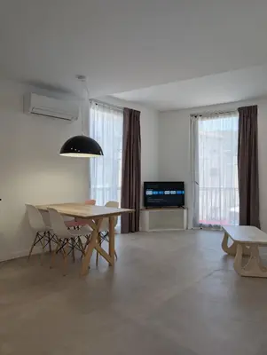 a dining room with a table and chairs and a television at Ca l'Emília, hasta 6 pers, Monistrol de Montserrat in Monistrol
