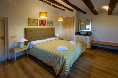 a bedroom with a bed with two towels on it at Cal Magí in San Martín Sarroca