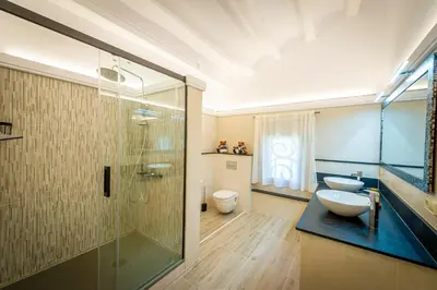 a bathroom with a shower and a sink and a toilet at Cal Magí in San Martín Sarroca