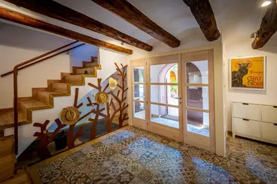 a room with a staircase and a door with a window at Cal Magí in San Martín Sarroca