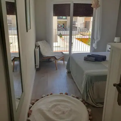 a bedroom with a bed and a view of a balcony at Benet Sitges in Sitges