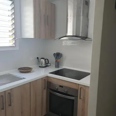 a kitchen with a sink and a stove at Benet Sitges in Sitges