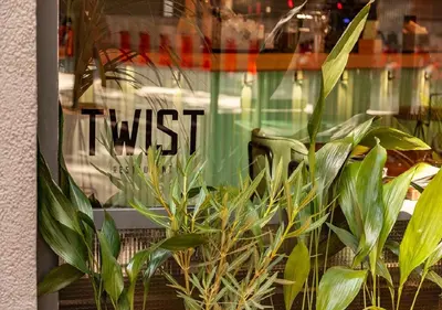 a window of a store with a bunch of plants at Sixties Ramblas in Barcelona