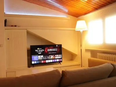 a living room with a couch and a flat screen tv at Winahost Loft en casa compartida en Cabrils in Cabrils