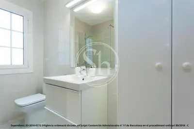 a white bathroom with a sink and a shower at Bonito apartamento para 3 en Poble Sec in Barcelona