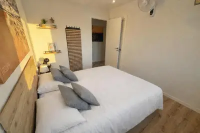 a bedroom with a white bed with pillows at Habitación premium in Vilanova i la Geltrú