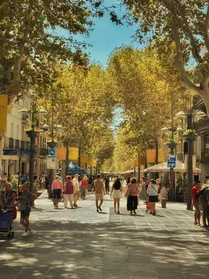 a group of people walking down a city street at Habitación premium in Vilanova i la Geltrú