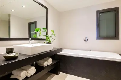 a bathroom with a large white tub and a sink at Sweett - Paseo de Gracia - City Centre in Barcelona