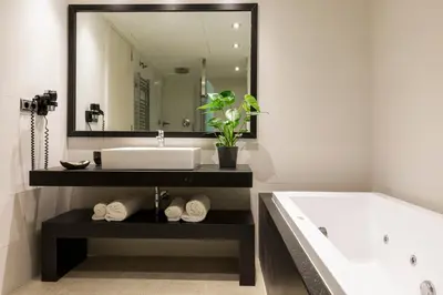 a bathroom with a tub and a sink and a mirror at Sweett - Paseo de Gracia - City Centre in Barcelona