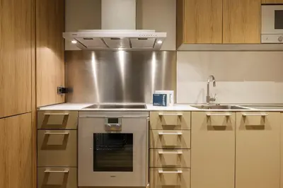 a kitchen with a stove and a sink at Sweett - Paseo de Gracia - City Centre in Barcelona