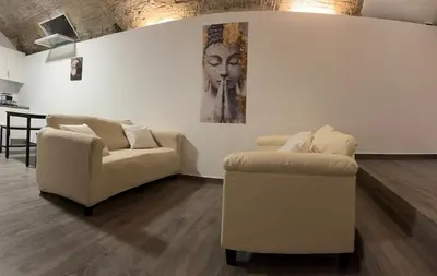a living room with two couches and a painting on the wall at Barcelona's Gem in Barcelona