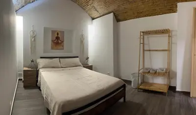 a bedroom with a large bed and a brick wall at Barcelona's Gem in Barcelona