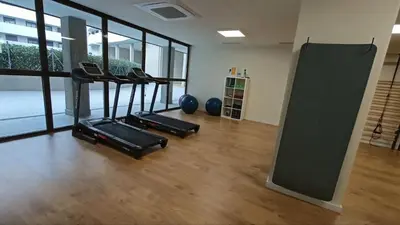a gym with three treadmills in a room at Contemporary 2BR with Pool & Gym in Hospitalet de Llobregat