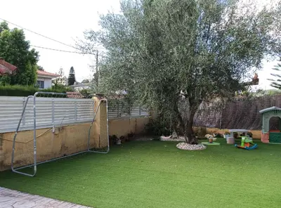 a yard with a tree and a soccer goal at Brad House in Can Trabal