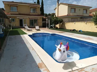 a plastic unicorn in a pool in front of a house at Brad House in Can Trabal