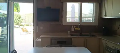 a kitchen with a sink and a counter with a window at Brad House in Can Trabal