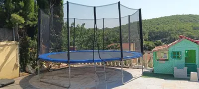 a trampoline with a net on a patio at Brad House in Can Trabal