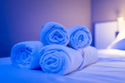 a pile of rolled towels on a bed at Hotel La Sagrera in Sant Fruitos de Bages