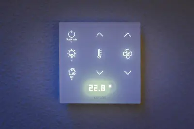 an electronic clock on a wall with icons on it at Hotel La Sagrera in Sant Fruitos de Bages
