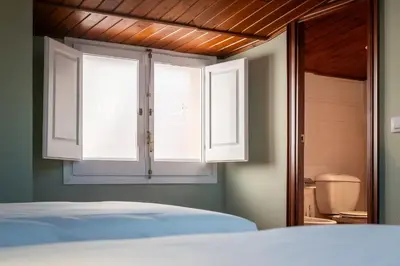 a bedroom with a bed and a window at Hotel La Sagrera in Sant Fruitos de Bages