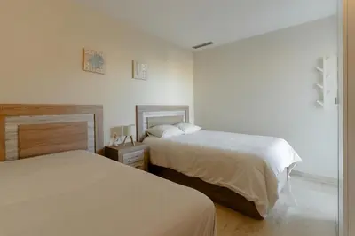 a bedroom with two beds and a mirror at Beachy House - Casa en Montgat, Barcelona in Montgat