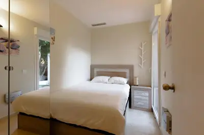 a bedroom with a bed and a glass wall at Beachy House - Casa en Montgat, Barcelona in Montgat