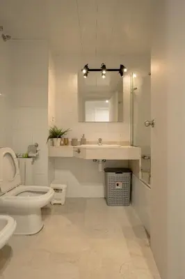a bathroom with a toilet and a sink and a mirror at Beachy House - Casa en Montgat, Barcelona in Montgat