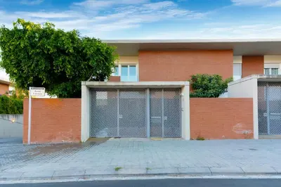 a red brick building with two garage doors at Beachy House - Casa en Montgat, Barcelona in Montgat