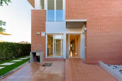 a brick building with a walkway in front of it at Beachy House - Casa en Montgat, Barcelona in Montgat
