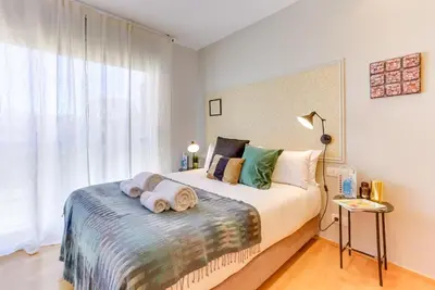 a bedroom with a large bed with towels on it at Sweett - Calabria in Barcelona